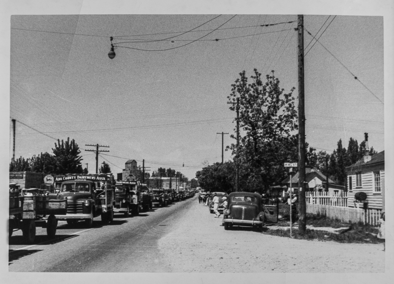 A large procession of Dairymen's Association trucks approach King Street in Meridian.