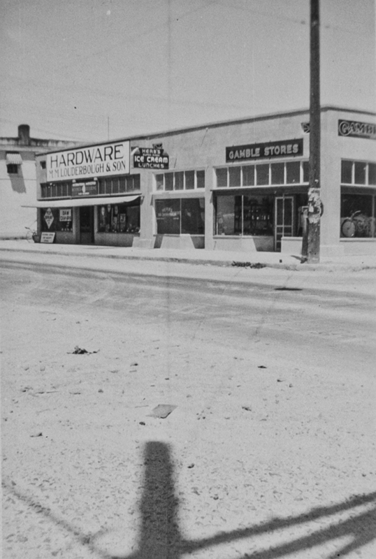 View of store fronts off Main & Broadway. M.M. Louderbough & Son and Gamble Store.