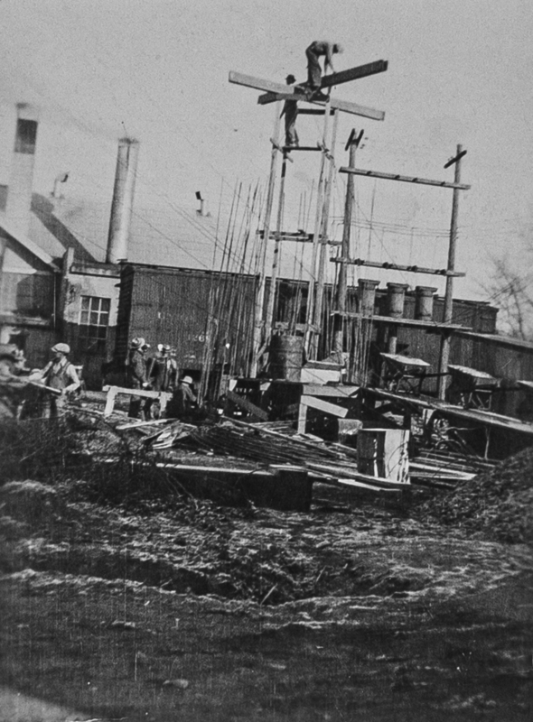 Workers constructing an addition to the creamery