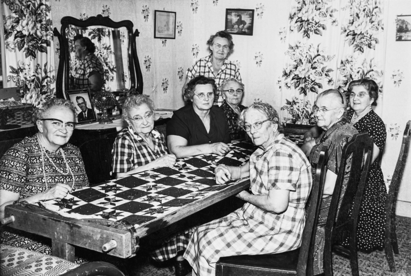 Copy of the ladies working on a quilt.