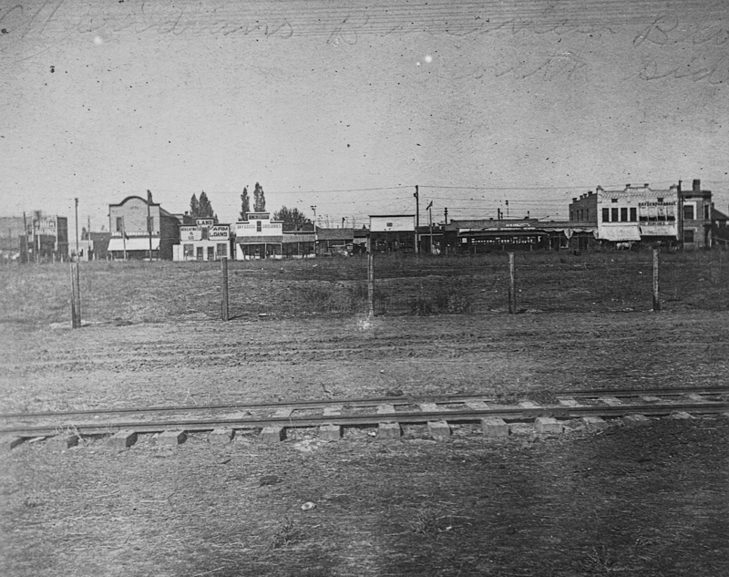 View of Meridian across a railroad track. Hayden Pharmacy is seen in the background.