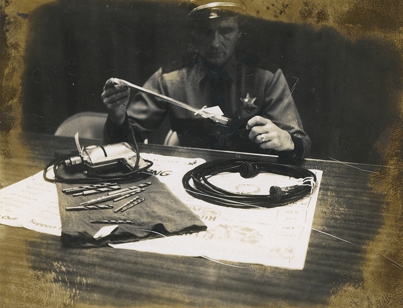 Gene Hiner examines tools taken from Richard Potter, a burglary suspect, October 20, 1965