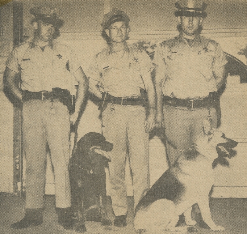 Picture of Meridian police dogs (a rottweiler and a German shepherd) with (from left to right): Richard Brumble, Police Chief Gene Hiner, and Alex Winn