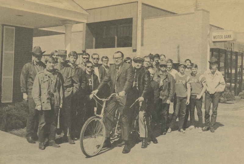 Delta Sigma Phi fraternity members from University of Idaho with Meridian Chamber of Commerce President John Fitzgerald and Police Chief Gene Hiner. Fraternity members perform yearly 400 mile bike ride from Moscow to Boise to publicize Idaho Easter Seal campaign. Fitzgerald and Hiner rode last few miles into Meridian with Meridian attorney Ivar J. Longetig behind Hiner.