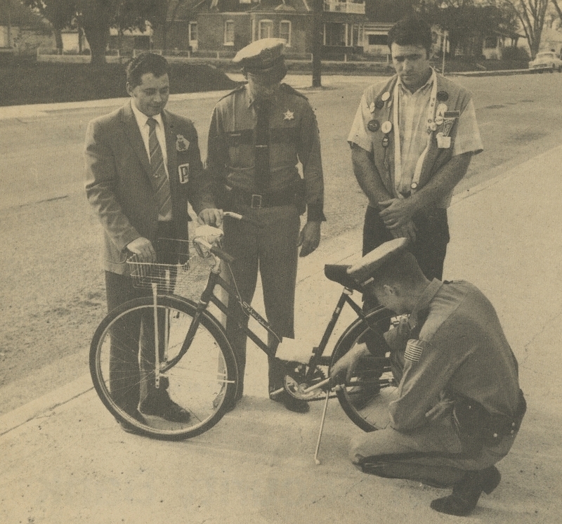 Idaho Jaycees sponsor an annual bicycle and motorcycle safety campaign. From left to right: Jim Heath (State President of Idaho Jaycees), Gene Hiner (Police Chief), Harlan Schildauer (Meridian Jaycee President), Robert Gaston (Meridian police officer)