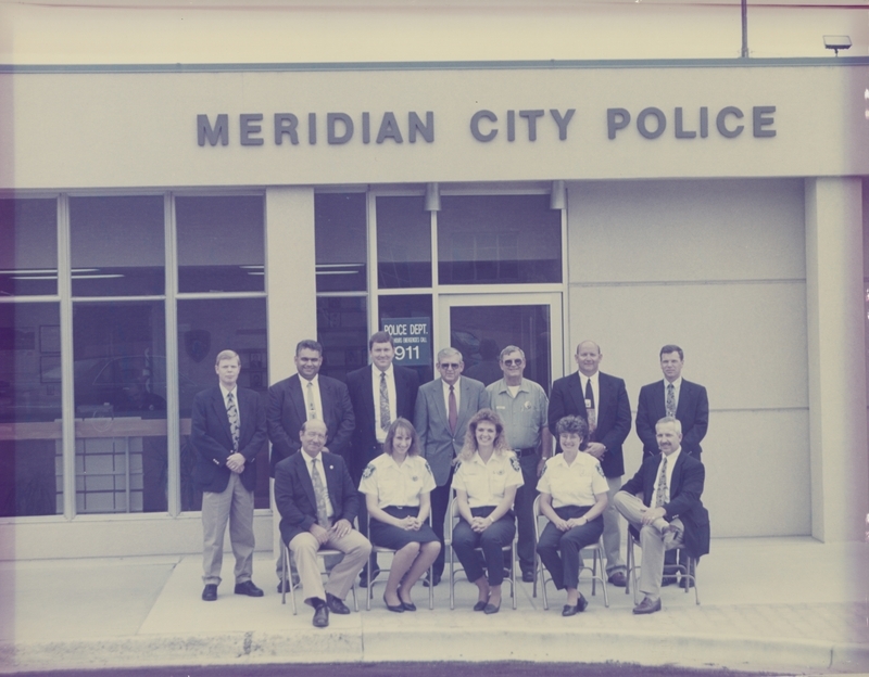 Meridian Police Department Staff on May 13, 1996. Front Row: Chief W.L. "Bill" Gordon, LaRee Crystal, Candy Tipton, Jean Moore, Lieutenant Dave Bowman; Back Row: Detective Jim Miller, Detective Mike Lock, Detective John Overton, Detective Norm Williams, Alan Riggle (Animal Control), Detective Dwight Hosford, Detective Joe Miller