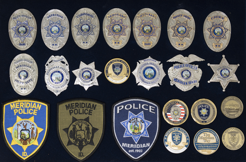 Framed collection of Meridian Police badges, patches, and coins collected and presented to Police Chief Jeff Lavey, circa 2007