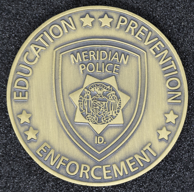 Meridian Police Coin 3-Back Side, 2007. Side of Coin focuses on three important responsibilities of Meridian Police Department-education, prevention, and enforcement.  