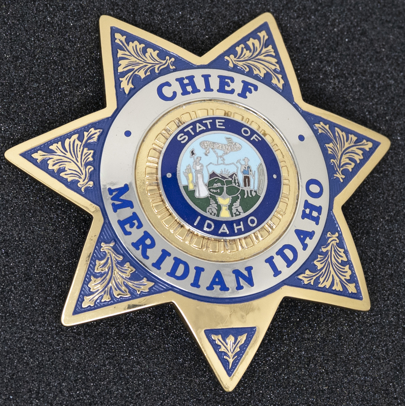 Meridian Patrolman Badge (Gold Star with floral gold)-this style of badge can be seen in this collection's black and white photo of Police Chief Bill Gordon. The badge's information is undated, but perhaps the late 1980s or early 1990s could be its age. 