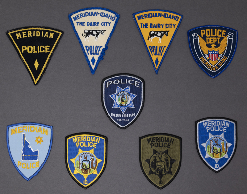 Framed collection of Meridian Police patches from circa 1950s to the latest issue released in 2012.