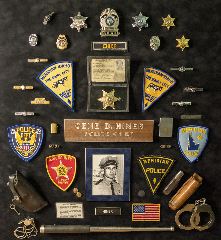 The Gene Hiner Family gave this framed display of items to the Meridian Police Department. It includes various items of Chief Hiner's throughout his police career (including outside of the Meridian Police Department) spanning 1954-1973. Items include badges, patches, pins, tie clips, police identification, lighters, a name plate, knife, handcuffs, whistle, and baton. Two of the Meridian Police police badges included (the eagle patch and the light blue patch) were from after his time as Police Chief.