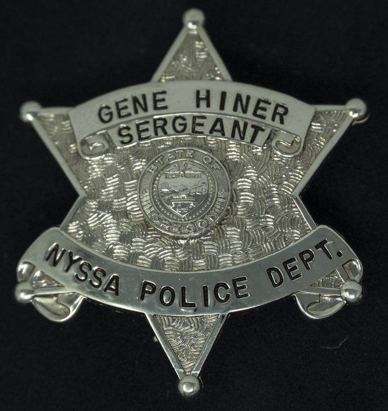 Gene Hiner's Sergeant-Nyssa Police Department Badge, from when he served with the Nyssa Oregon Police Departrment in 1961. Part of the Gene Hiner Police Career Display presented to the MPD by Gene Hiner's family. 