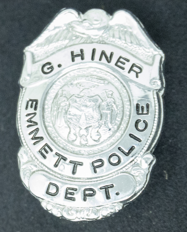 Gene Hiner Emmett Police Department Pin. Hine served in the Emmett Police Department in 1962. Part of the Gene Hiner Police Career Display presented to the MPD by Gene Hiner's family.