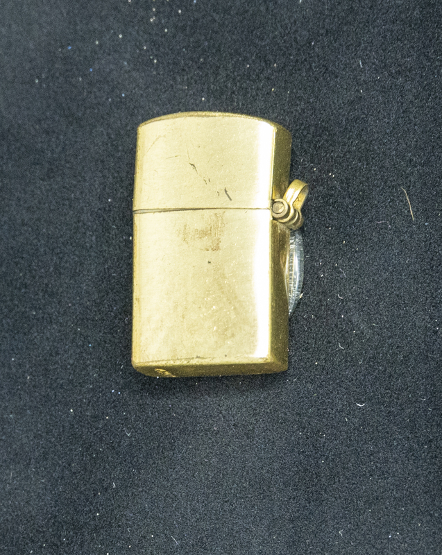 Gene Hiner tiny lighter, which could have been used anyime during his 1954-1973 police officer career. Part of the Gene Hiner Police Career Display presented to the MPD by Gene Hiner's family. 