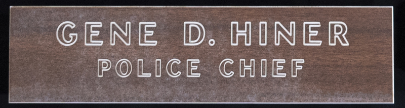 Gene Hiner Police Chief door plate, which would have been used during Hiner's 1963-1973 service as Meridian Police Chief. Part of the Gene Hiner Police Career Display presented to the MPD by Gene Hiner's family. 