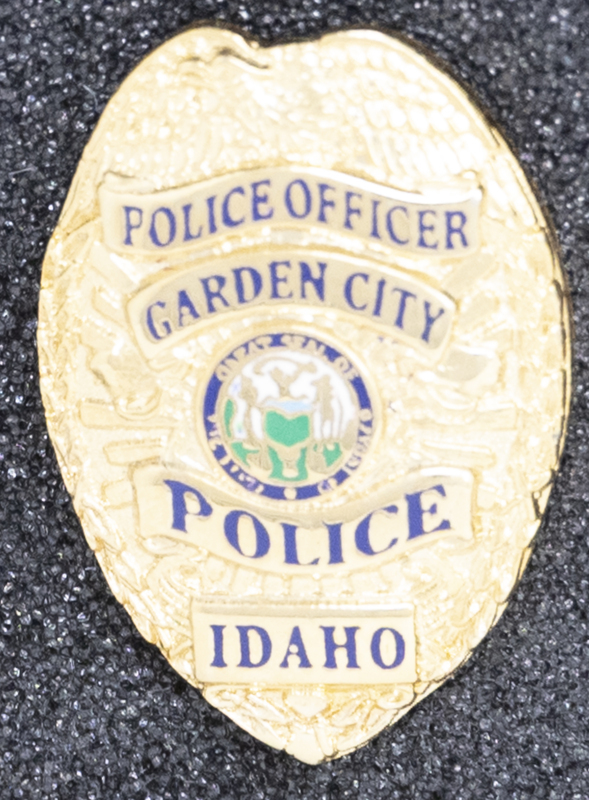 Garden City Police Officer badge, part of MPD's Idaho patch and badge collection circa 2007. The patch and badge collection hangs on the MPD meeting room wall, and indicates the respect Meridian Police officers have for other police in the surrounding areas.