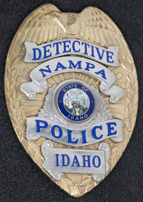 Nampa Police Detective badge, part of MPD's Idaho patch and badge collection circa 2011. The patch and badge collection hangs on the MPD meeting room wall, and indicates the respect Meridian Police officers have for other police in the surrounding areas.