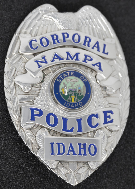 Nampa Police Corporal badge, part of MPD's Idaho patch and badge collection circa 2011. The patch and badge collection hangs on the MPD meeting room wall, and indicates the respect Meridian Police officers have for other police in the surrounding areas.