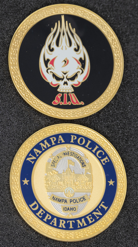 Nampa Police Special Investigations Unit coin (front & back), part of MPD's Idaho patch and badge collection circa 2011. The patch and badge collection hangs on the MPD meeting room wall, and indicates the respect Meridian Police officers have for other police in the surrounding areas.