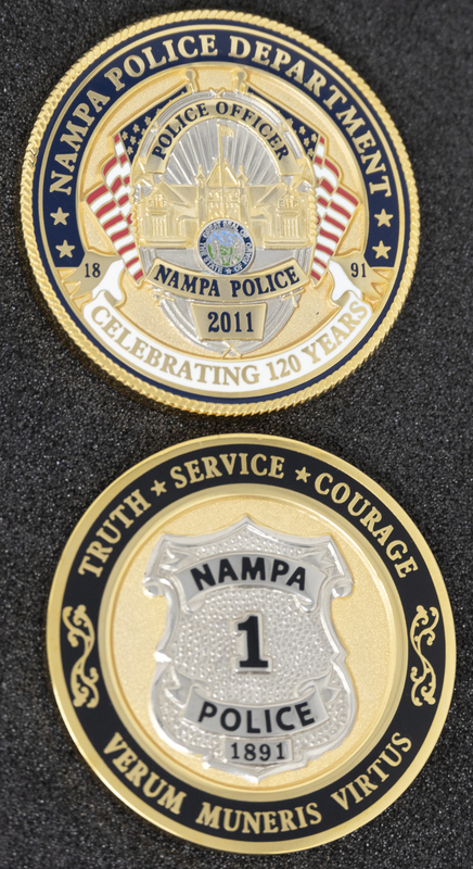 Nampa Police 120th Anniversary coin (front & back), part of MPD's Idaho patch and badge collection circa 2011. The patch and badge collection hangs on the MPD meeting room wall, and indicates the respect Meridian Police officers have for other police in the surrounding areas.