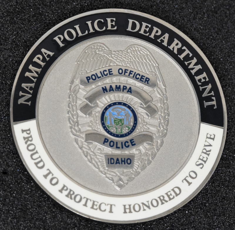 Nampa Police Department Integirity, Honor, Respect coin (front), part of MPD's Idaho patch and badge collection circa 2011. The patch and badge collection hangs on the MPD meeting room wall, and indicates the respect Meridian Police officers have for other police in the surrounding areas.