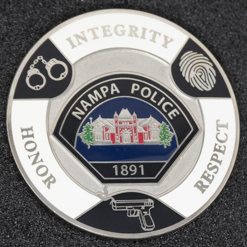 Nampa Police Integrity, Honor, Respect coin (back), part of MPD's Idaho patch and badge collection circa 2011. The patch and badge collection hangs on the MPD meeting room wall, and indicates the respect Meridian Police officers have for other police in the surrounding areas.