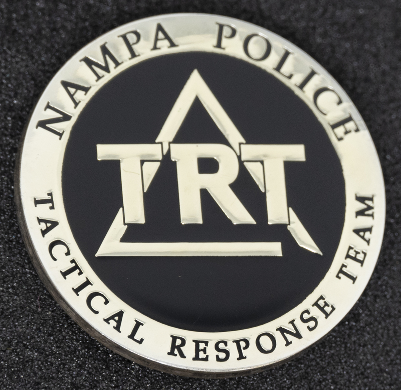 Nampa Police Tactical Response Team coin (back), part of MPD's Idaho patch and badge collection circa 2011. The patch and badge collection hangs on the MPD meeting room wall, and indicates the respect Meridian Police officers have for other police in the surrounding areas.