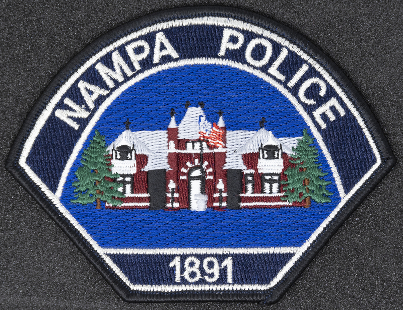 Nampa Police Department patch, part of MPD's Idaho patch and badge collection circa 2011. The patch and badge collection hangs on the MPD meeting room wall, and indicates the respect Meridian Police officers have for other police in the surrounding areas.