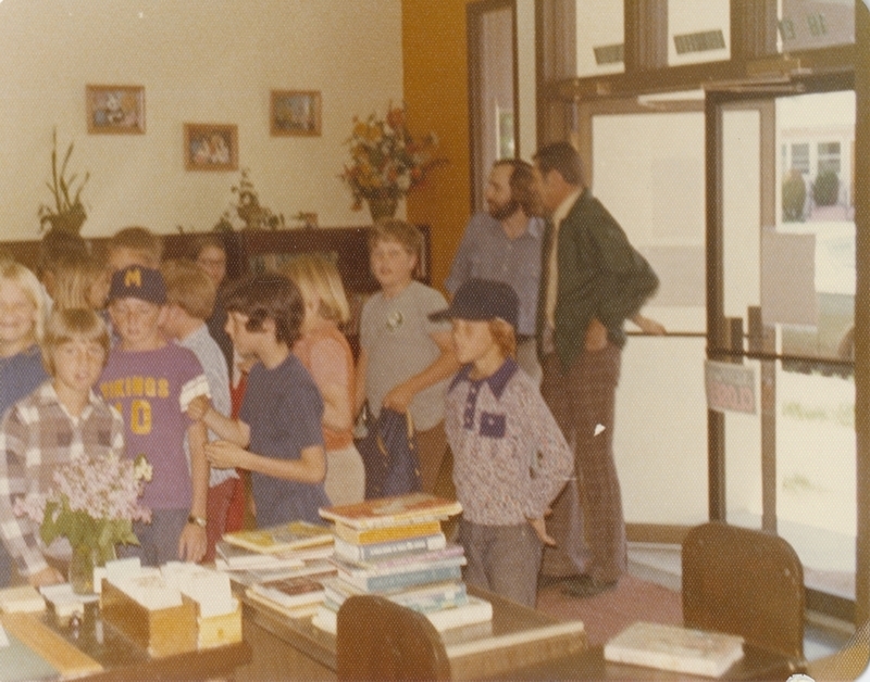 Librarian Grove Koger talks with a visiting school teacher as his class visits the library on a field trip. 