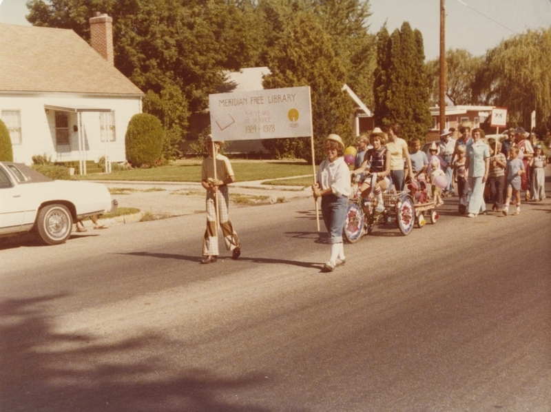 Meridian's 75th Birthday Parade, July 27, 1978. Judy Olson seen carrying the "Meridian Free Library" sign.