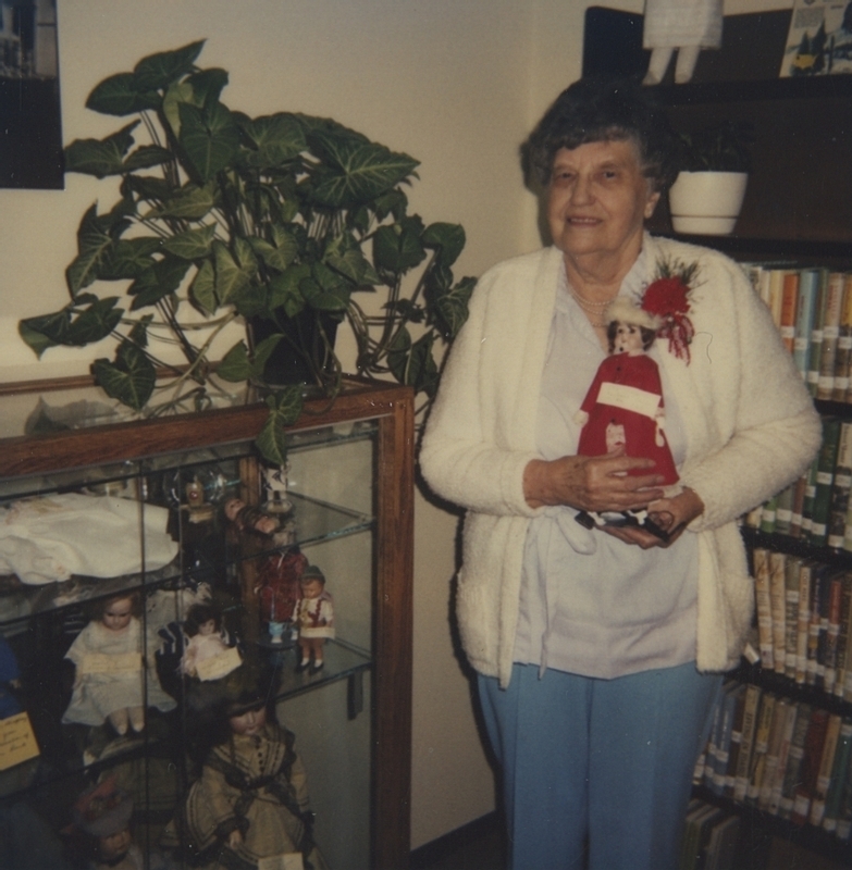 Leone Lund, the Occident Club President, displays her doll collection in the Meridian Library. 