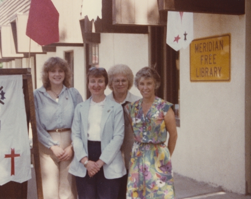 Meridian Library employees stand outside the library during a Castle Day Event. From left to right: Roben, Nancy, Evelyn, and Kay