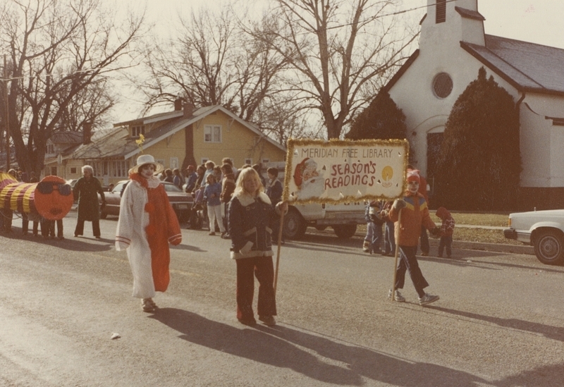 Library parade walkers proceed through the Holiday Parade route.