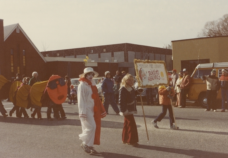 Library parade walkers proceed through the Holiday Parade route.