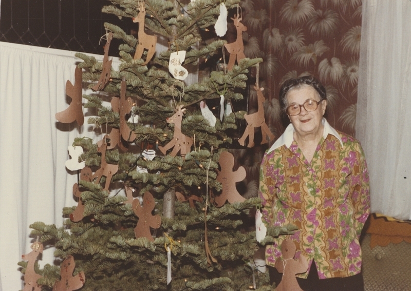 Retired librarian Nancy Sage stands next to the Children's Tree.