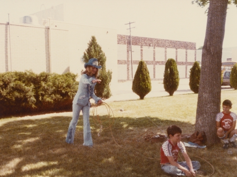 Myla Meiers, Caldwell Night Rodeo champion demonstrates lassoing on a boy from the audience.