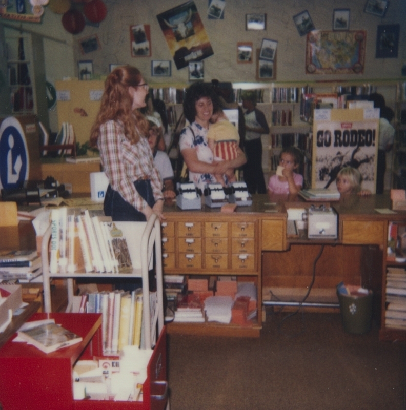 Librarian Denise greets patrons for the last scheduled event of the 1983 summer reading program. The program was Western themed, and for the closing event attendees watched a movie and ate cotton candy. 