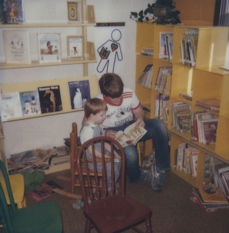 Brothers Mark and Matthew Johnston sit down together as Mark reads "several books to Matthew with lots of storytelling spark." 