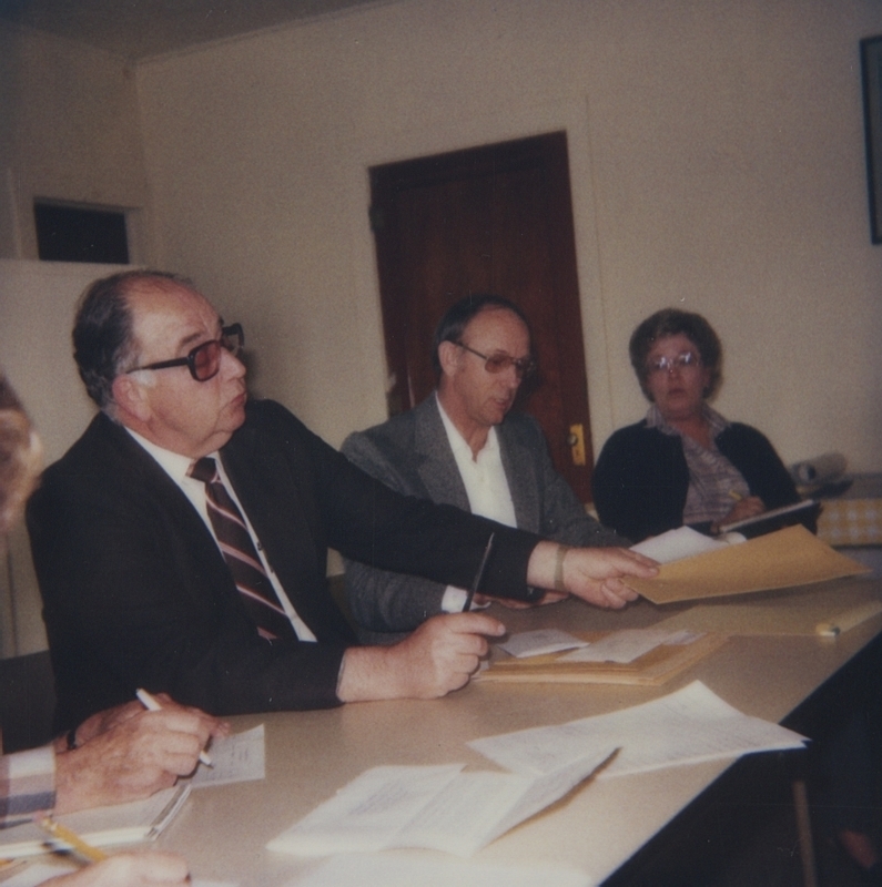 Meridian Library Board Chairman Jack Riddlemoser conducting the opening of bids for a new library expansion project. 