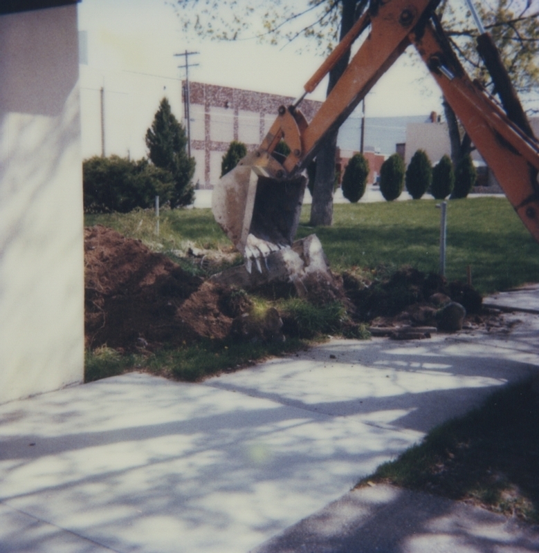 Digging commences in the grassy area next to the library for the expansion project. 