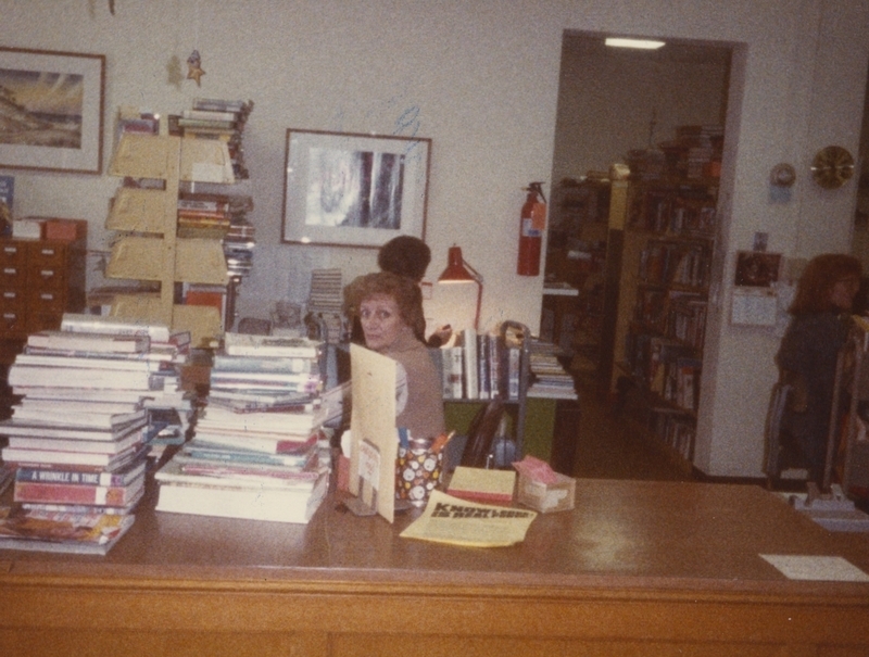 A library employee works at her deak.