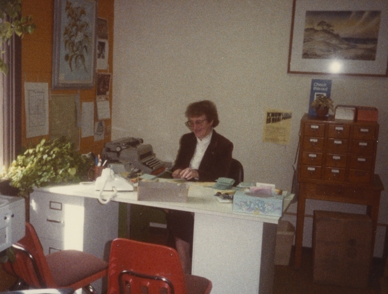 A library employee works at her deak.