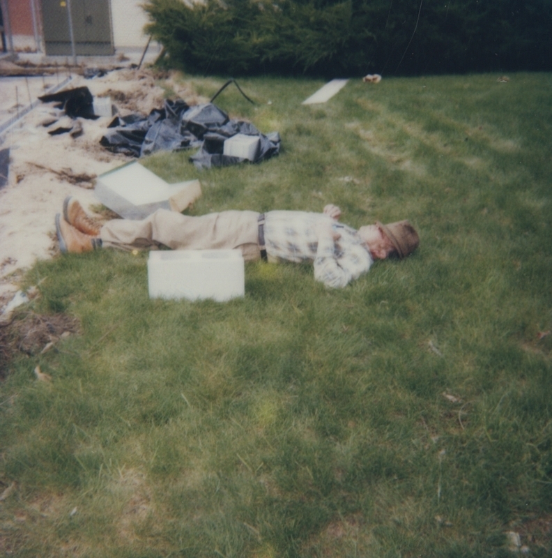 Picture of a man laying down near the library construction site. 