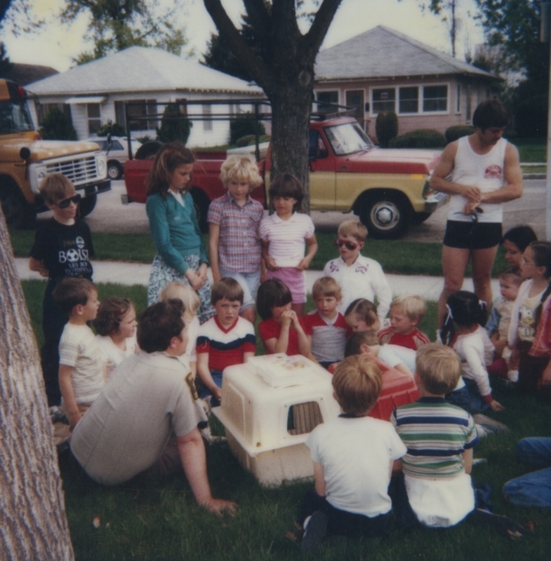 Children gathered around animal carriers on the library lawn with Bob Gregory from the Boise animal shelter. The program was part of Be Kind to Animals Week by the Boise animal shelter.