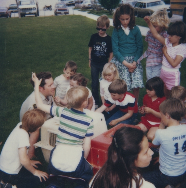 Children gathered around animal carriers on the library lawn with Bob Gregory from the Boise animal shelter. The program was part of Be Kind to Animals Week by the Boise animal shelter.