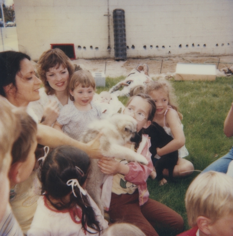 Bob Gregory of the Boise animal shelter brought along some friends to the Meridian Library for Be Kind to Animals Week. Here, the children look at and hold a puppy.