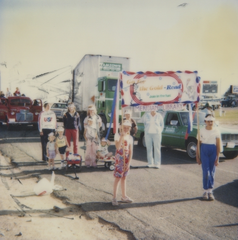 The Meridian Library had staff and patrons walk in the Meridian Dairy Days Parade. During the parade they promoted the library's Go For the Gold olypmic games themed summer reading program. 