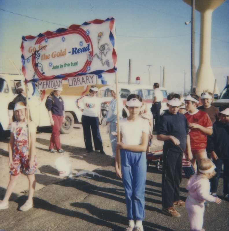 The Meridian Library had staff and patrons walk in the Meridian Dairy Days Parade. During the parade they promoted the library's Go For the Gold olypmic games themed summer reading program. 