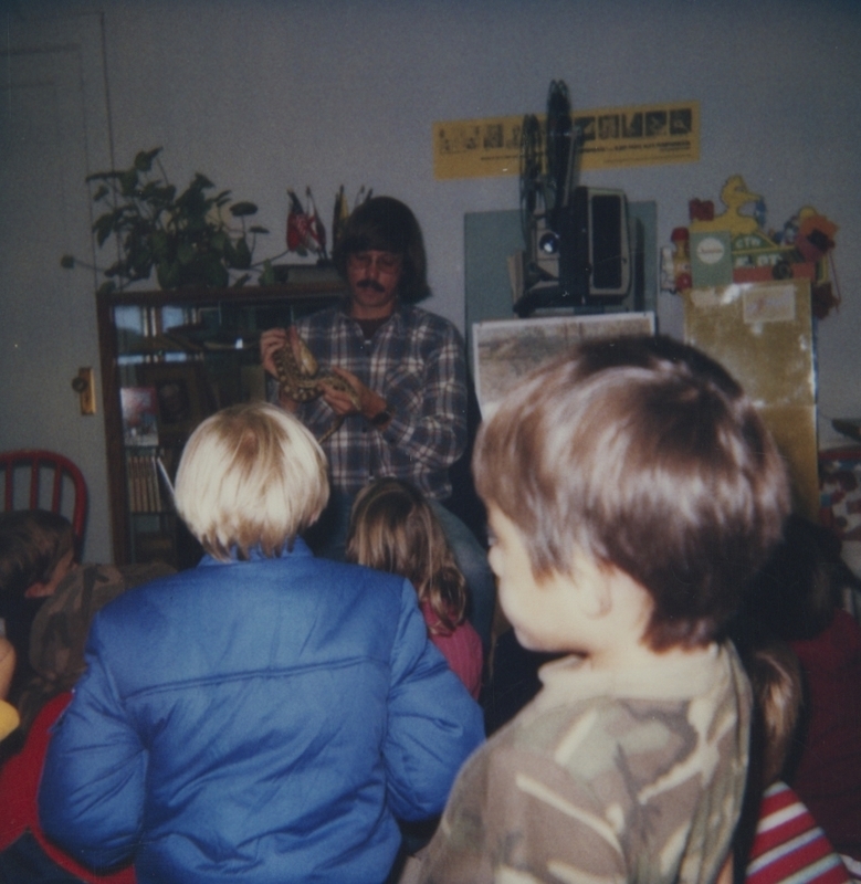 Children watch Hermie the Snake as Ralph leads a library event. 