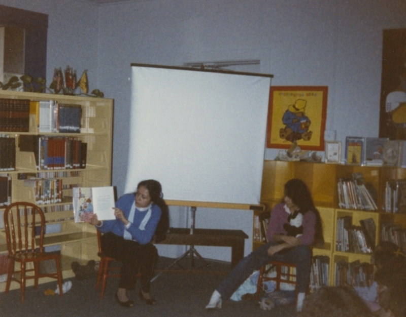 Laura Oberbillig reads a book to children during story hour. 